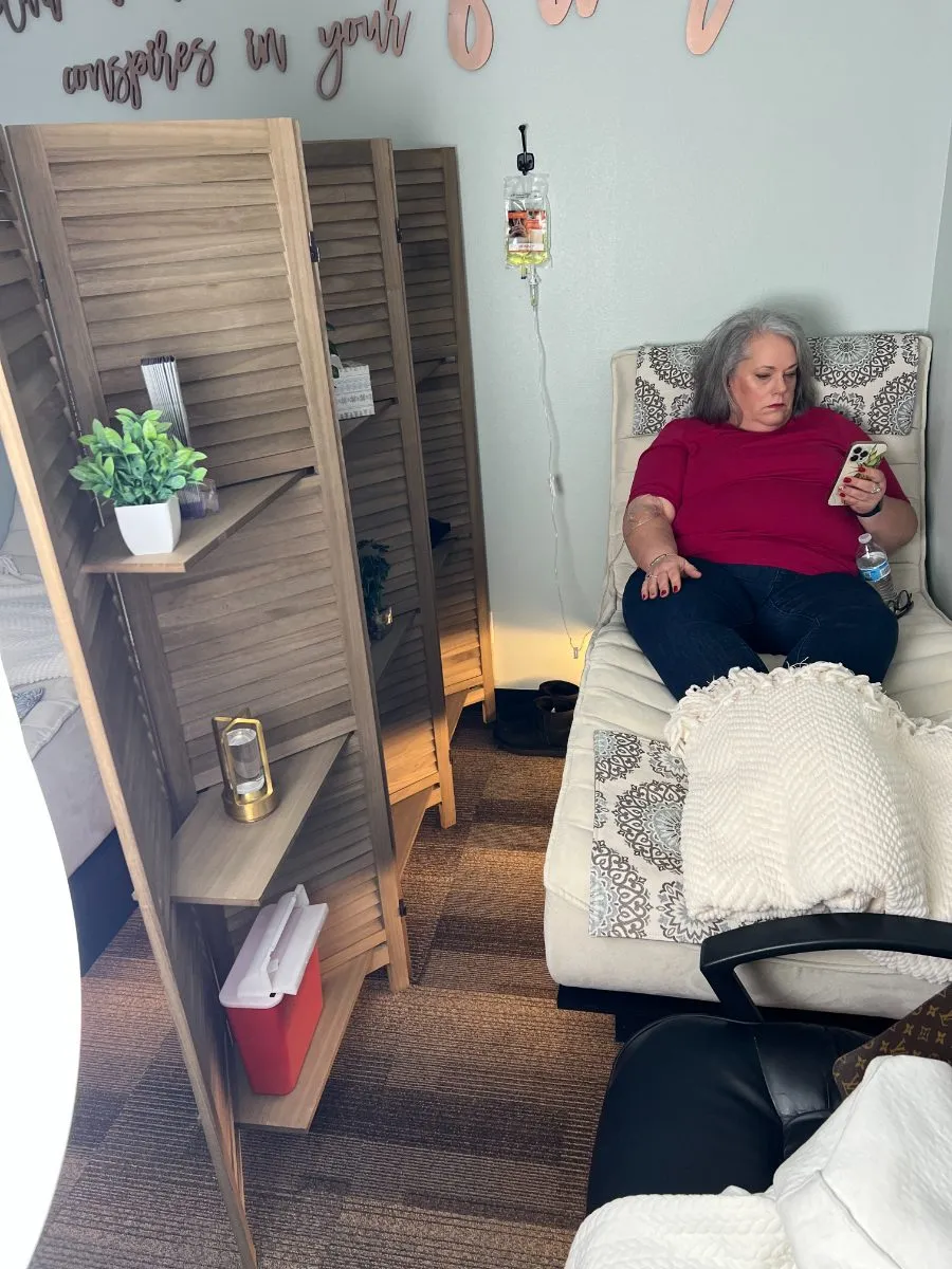A client relaxing in a recliner during an infusion