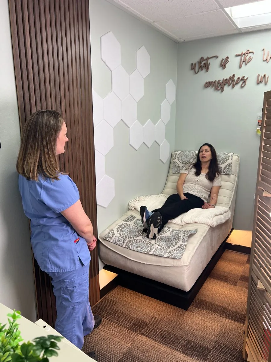 A nurse and a client talking in the treatment room